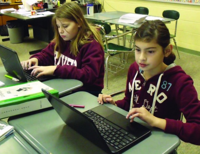 Educations-Invisible-Revolution-2girls-each-work-onlaptops